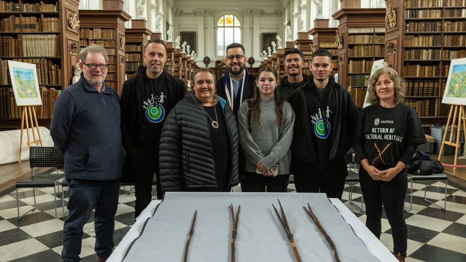 The spears pictured with a number of those involved in their repatriation. - AIATSIS