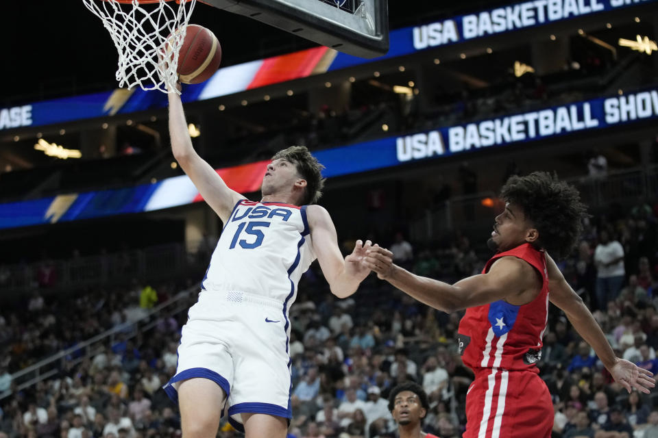 United States' Austin Reaves (15) shoots over Puerto Rico's Stephen Thompson Jr., right, during the first half of an exhibition basketball game Monday, Aug. 7, 2023, in Las Vegas. (AP Photo/John Locher)