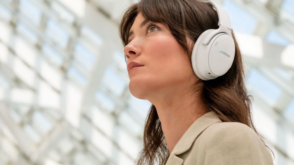  Person wearing Bose QuietComfort headphones. 