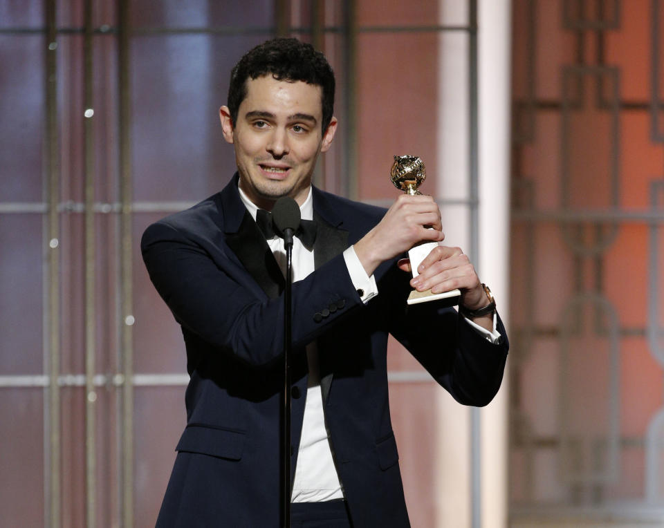 This image released by NBC shows Damien Chazelle with the award for best screenplay for "La La Land," at the 74th Annual Golden Globe Awards at the Beverly Hilton Hotel in Beverly Hills, Calif., on Sunday, Jan. 8, 2017. (Paul Drinkwater/NBC via AP)