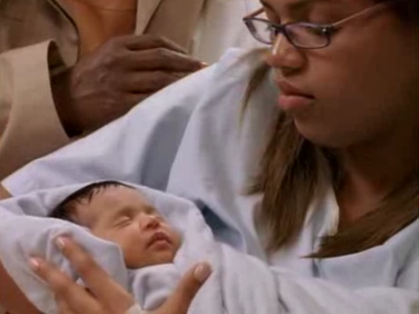 A woman holding her newborn baby