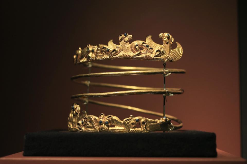 A spiraling torque from the second century A.D., is displayed as part of the exhibit called The Crimea - Gold and Secrets of the Black Sea, at Allard Pierson historical museum in Amsterdam Friday April 4, 2014. The museum has gotten more than the bronze swords, golden helmets and precious gems it bargained for as it is unsure where to return the collection after Russia annexed Crimea. (AP Photo/Peter Dejong)