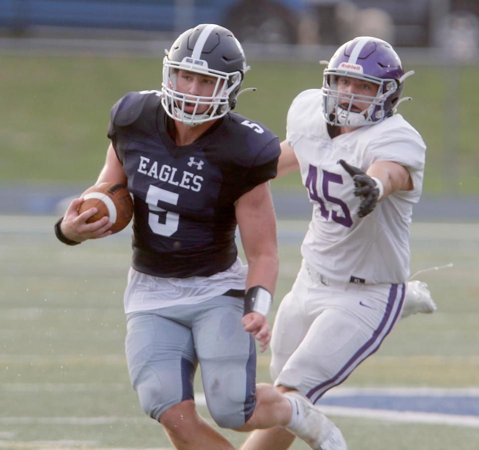 Middletown South's Colin Gallagher (#5) stays just ahead of the reach of Rumson-Fair Haven's Austin Kiernan during their game at Middletown Friday evening, August 25, 2023.