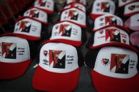 Caps depicting Lionel Messi with a message that reads in Spanish: "Your dream is our illusion," are displayed for sale on the route of a caravan organized by Newell's Old Boys soccer club in Messi's hometown, in Rosario, Argentina, Thursday, Aug. 27, 2020. Fans hope to lure him home following his announcement that he wants to leave Barcelona F.C. after nearly two decades with the Spanish club. (AP Photo/Natacha Pisarenko)