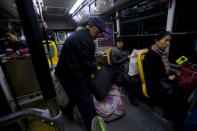 Li Nan (2nd R), a makeup artist, takes a bus on her way to Beijing for work from Tianjin, China, November 18, 2015. REUTERS/Jason Lee