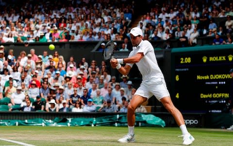 Serbia's Novak Djokovic returns against Belgium's David Goffin during their men's singles quarter-final match on day nine of the 2019 Wimbledon Championships at The All England Lawn Tennis Club in Wimbledon - Credit: AFP