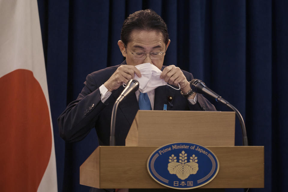 Prime Minister of Japan Fumio Kishida puts his mask on during a news conference on Thursday, Sept. 22, 2022 in New York. (AP Photo/Andres Kudacki)