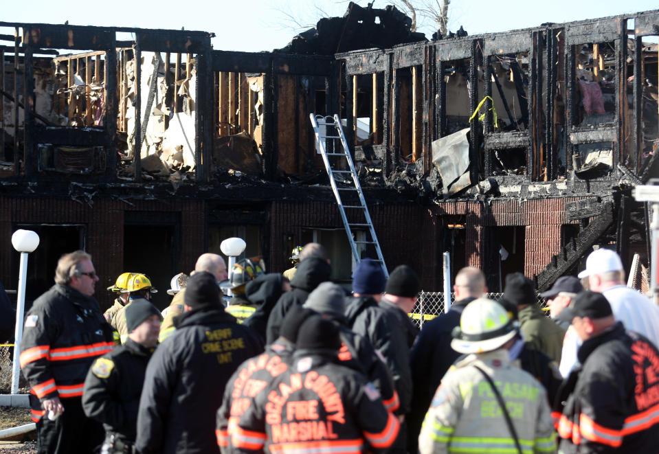 Firefighters investigate an early morning fire at the Mariner's Cove Hotel in Point Pleasant Beach, N.J. on Friday, March 21, 2014. (AP Photo/David Gard)