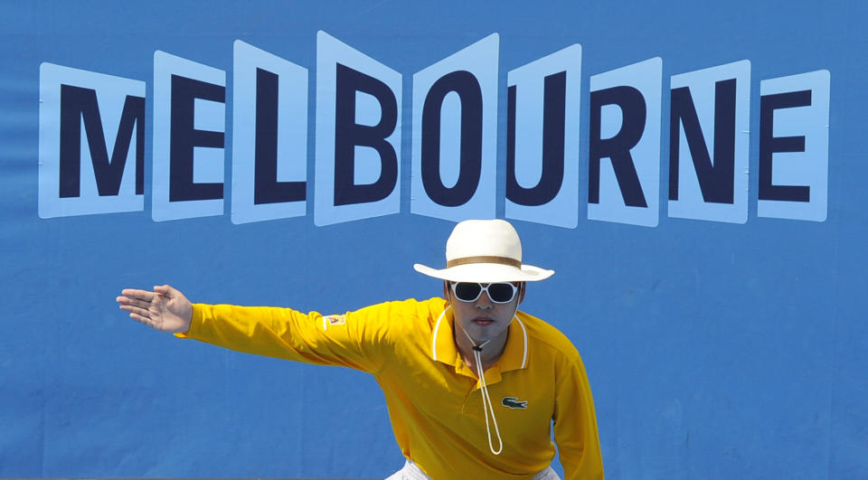 FILE - In this Jan. 21, 2011 file photo, A linesman gestures that a ball is out during a third round match between Spain's Nicolas Almagro and Croatia's Ivan Ljubicic at the Australian Open tennis championships in Melbourne, Australia. In a Grand Slam-first, at the 2021 Australian Open tennis championships, there will be no on-court line judges on any of the tournament courts in an effort to reduce the number of staff on-site due to coronavirus-related concerns. Only chair umpires and ball persons will be on the court. (AP Photo/Andrew Brownbill,File)