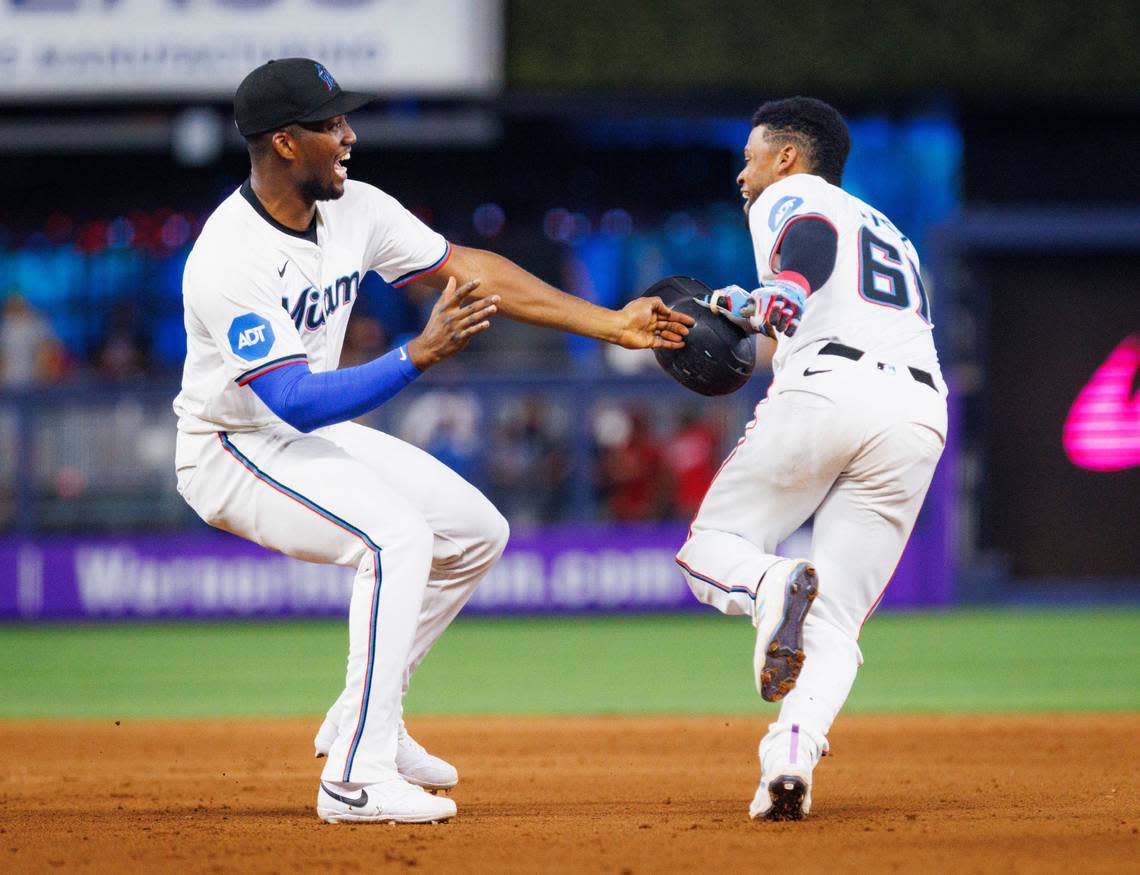 Miami Marlins outfielder Jesús Sánchez (12) runs up to Otto Lopez (61) after he hits a walk-off single winning the game against the St. Louis Cardinals on Wednesday, June 19, 2024 at loanDepot Park in Miami, Fla.