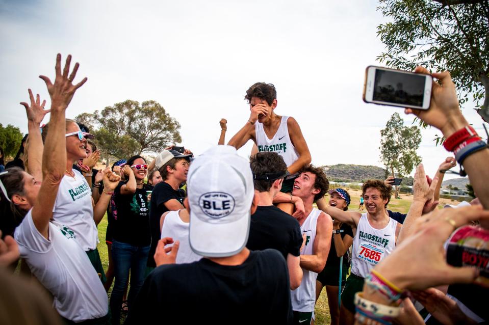 The Flagstaff boys team celebrates during the state cross-country championships at Cave Creek Golf Course in Phoenix on Friday, Nov. 15, 2019.