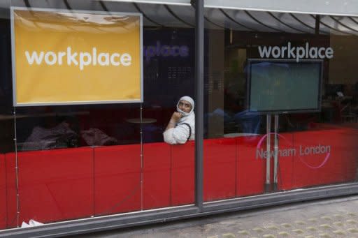 A woman sits in Workplace Newham, a council run facility to make sure local people benefit from local regeneration on the High Street in Stratford, east London on August 15, 2012. London may have basked in the euphoria of a successful Olympics in 2012 but now that the party is over, local people are wondering if its legacy can improve the deprived area which hosted the Games