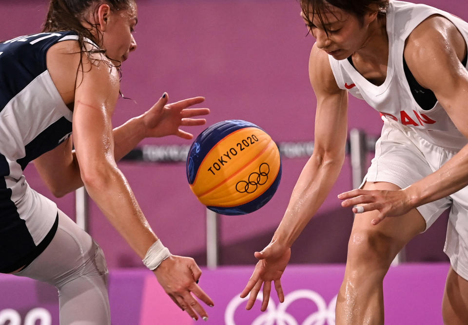 <p>France's Marie-Eve Paget (left) fights for the ball against Japan's Mio Shinozaki during the women's quarterfinal 3x3 basketball match between Japan and France.</p>