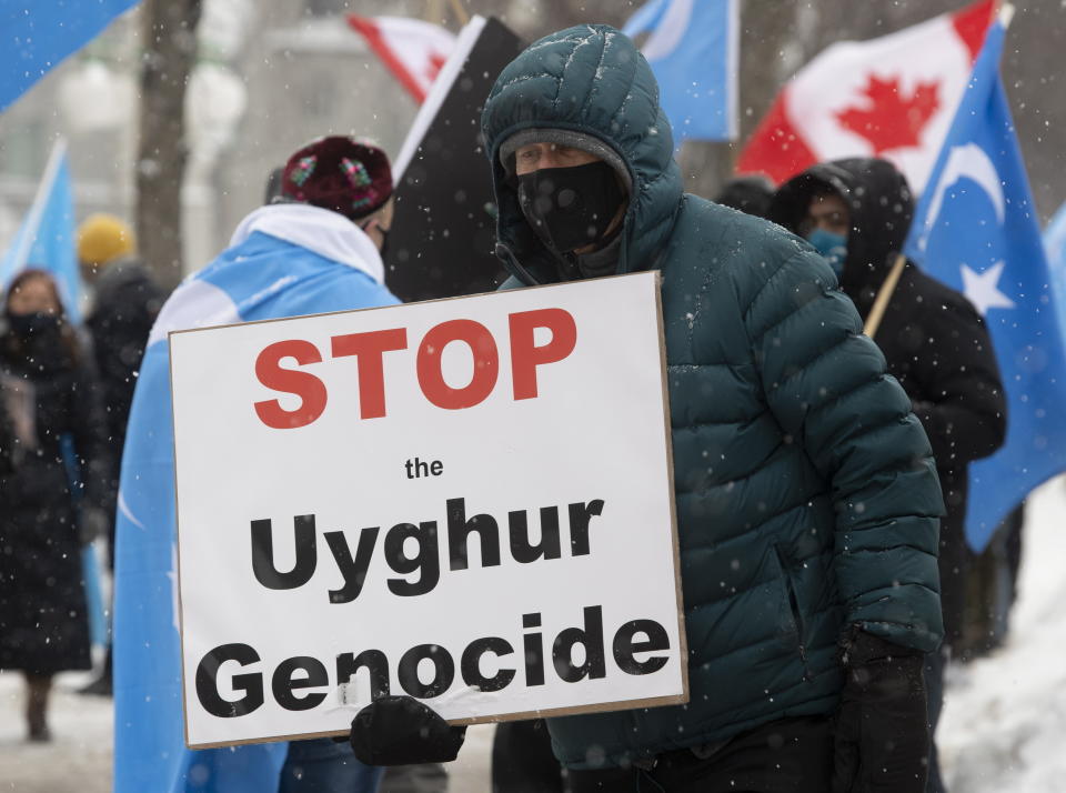 Protesters gather outside the Parliament buildings in Ottawa, Ontario Monday, Feb. 22, 2021. Parliament is expected to vote on an opposition motion calling on Canada to recognize China's actions against ethnic Muslim Uighurs as genocide. (Adrian Wyld/The Canadian Press via AP)