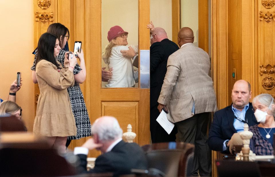 Jan 24, 2024; Columbus, Ohio, United States; A person is removed from the Senate Chambers after shouting in support of trans rights during a debate and vote in the Ohio Senate on whether or not to override Governor Mike DeWine's veto of House Bill 68.