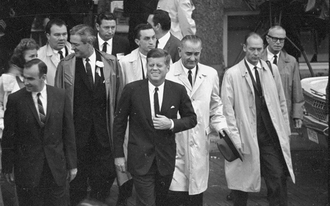President John F. Kennedy walking with group of men including, from left, Jim Wright, Don Kennard, Gov. John Connally, and Vice President Lyndon B. Johnson, Fort Worth, 11/22/1963