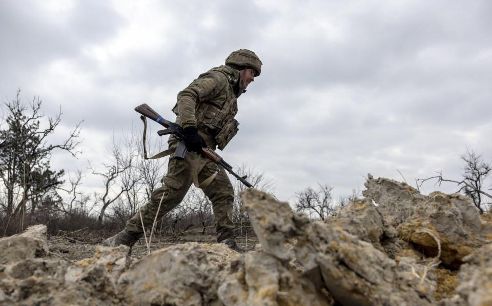 A Ukrainian infantryman with the 28th Brigade runs along a frontline position facing Russian troops outside of Bakhmut - John Moore/Getty Images Europe