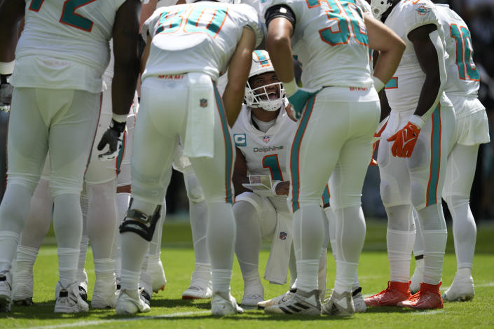Miami Dolphins quarterback Tua Tagovailoa (1) talks to the offensive line during the first half of an NFL football game against the Buffalo Bills, Sunday, Sept. 25, 2022, in Miami Gardens, Fla. (AP Photo/Rebecca Blackwell)