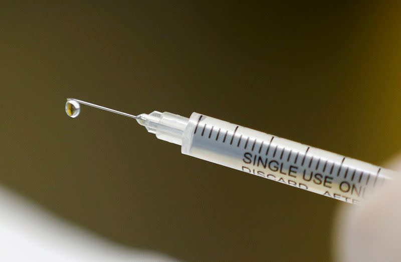 FILE PHOTO: A syringe with a vaccine is seen ahead of trials by volunteers testing for the coronavirus disease (COVID-19), and taking part in the country's human clinical trial for potential vaccines at the Wits RHI Shandukani Research Centre in Johannesbu