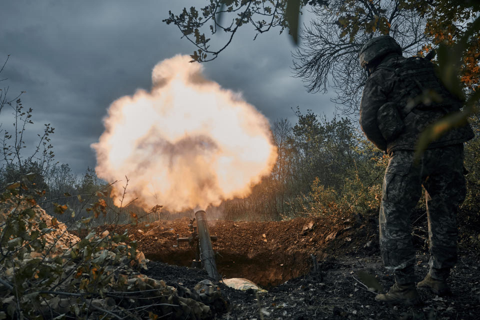 Ukrainian soldiers fire the Russian positions with the mortar in Bakhmut, Donetsk region, Ukraine, Friday, Oct. 21, 2022. (AP Photo/LIBKOS)