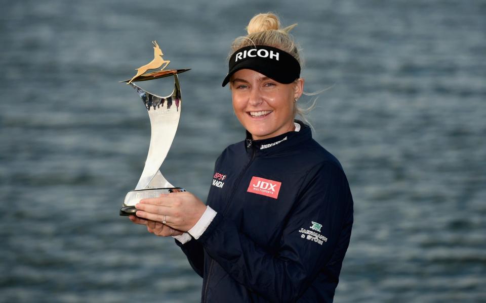 Charley Hull poses with her trophy after taking the win in Abu Dhabi - Getty Images Europe