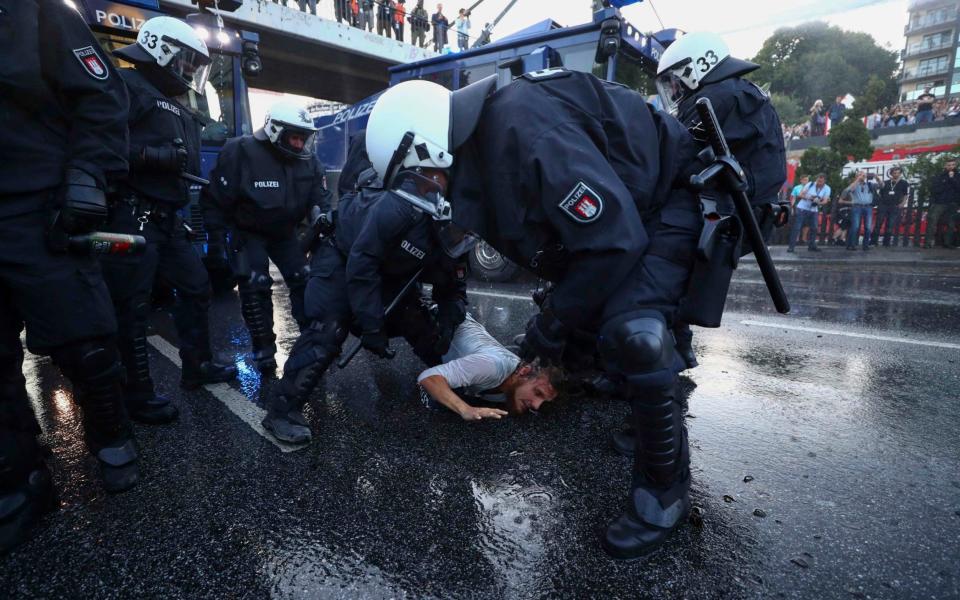 German riot police detain a protester during the demonstrations during the G20 summit in Hamburg - Credit: Reuters