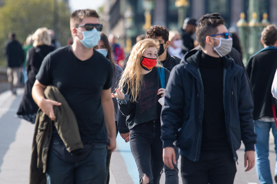 People wearing protective face masks in Westminster, London, after a range of new restrictions to combat the rise in coronavirus cases came into place in England.