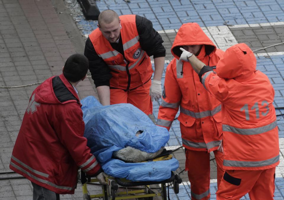 Paramedics use a stretcher to move a body from a collapsed supermarket in capital Riga