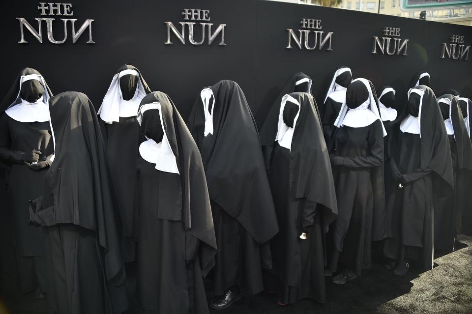 Nun statues and real people dressed as nuns are seen lining the carpet for the premiere of the film "The Nun", at the TCL Chinese Theatre in Hollywood, California on September 4, 2018. (Photo by Robyn Beck / AFP)        (Photo credit should read ROBYN BECK/AFP/Getty Images)