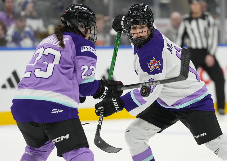 Team King's Alina Muller (11) battles for the puck against Team Kloss' Erin Ambrose (23) during the PWHL 3-on-3 Showcase at the NHL All-Star hockey week in Toronto on Thursday, Feb. 1, 2024. (Frank Gunn/The Canadian Press via AP)