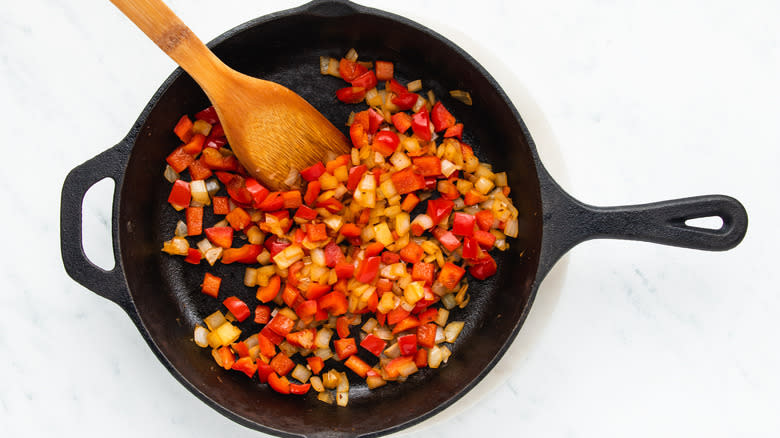 Onion and red pepper frying in skillet