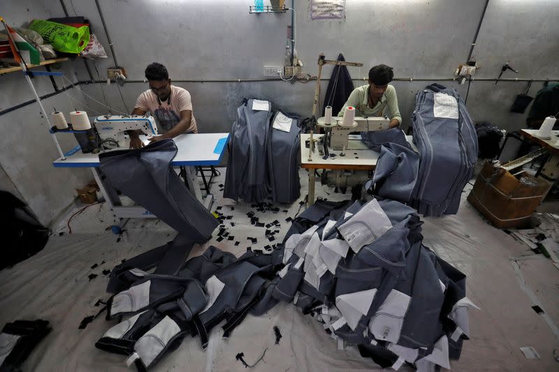 Workers sew jeans in a garments manufacturing unit in Ahmedabad