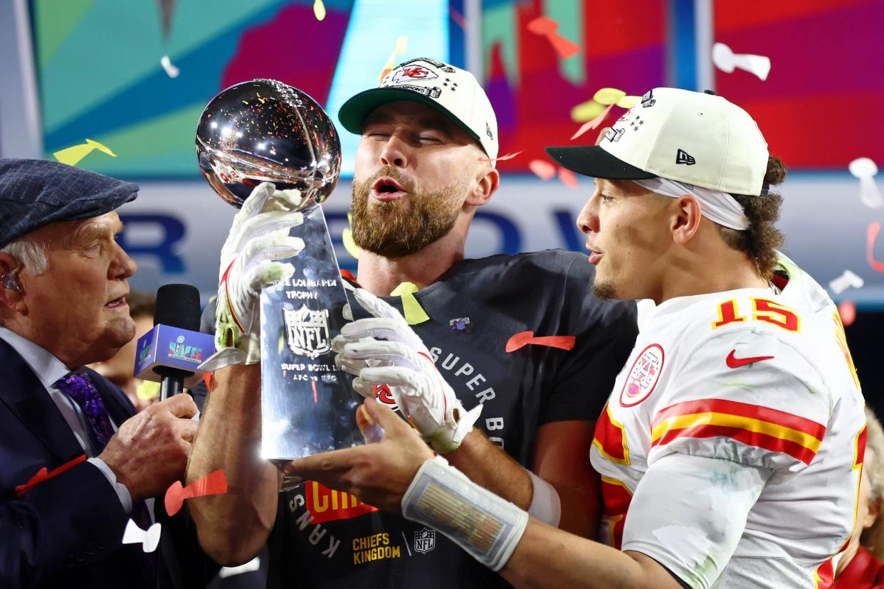 Travis Kelce and Patrick Mahomes celebrate with the Lombardi Trophy after the Chiefs won Super Bowl 57.