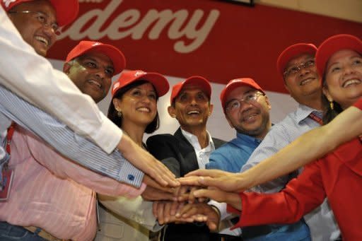 Newly appointed AirAsia CEO of Malaysian Operations Aireen Omar (third left) joins Group CEO Tony Fernandes (second left), and other top officials at a ceremony in Sepang, outside Kuala Lumpur on Monday. Fernandes on Monday said he was handing over his role as head of Malaysia operations to shift focus to oversee the budget carrier's regional expansion