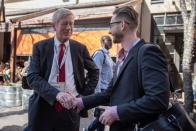 Former Massachusetts Governor Bill Weld shakes hands with a supporter at the South by Southwest (SXSW) conference and festivals in Austin, Texas