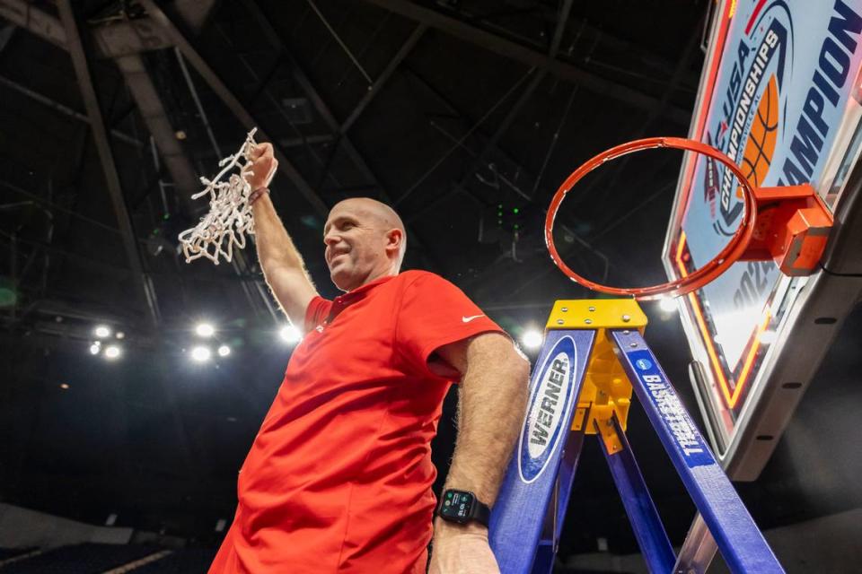 Western Kentucky head coach Steve Lutz hoists the net as his team celebrates its win against UTEP in the Conference USA Tournament championship game on Saturday in Huntsville, Alabama.