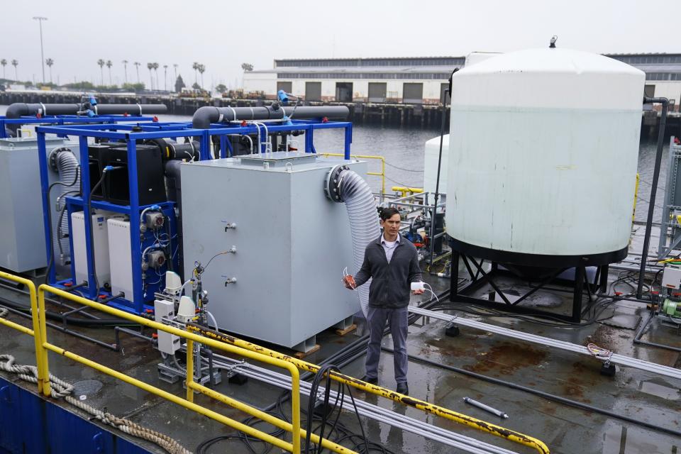 Dante Simonetti, associate professor and vice chair for undergraduate education at the UCLA Samueli Chemical and Biomolecular Engineering Department, explains a technology dubbed SeaChange during a news conference, Wednesday, April 12, 2023, in San Pedro, Calif. Engineering faculty the university say they have developed a technique that can remove carbon dioxide from seawater and produce hydrogen, a green energy fuel, in the process. (AP Photo/Ashley Landis)