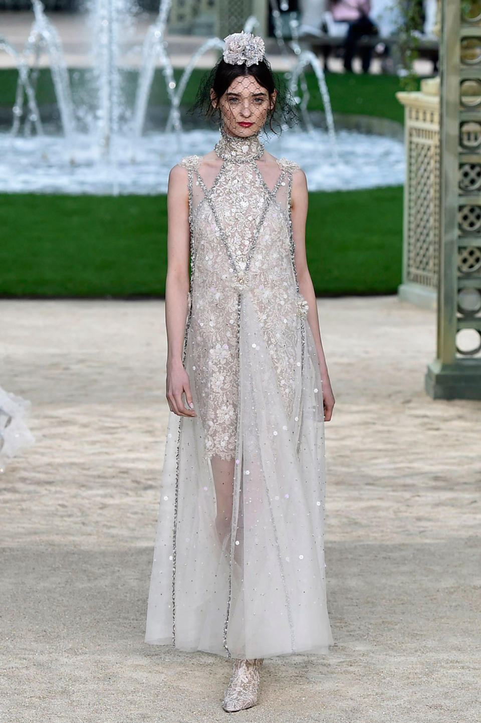 <p>Model wears a couture version of the “choker dress,” decorated with floral appliqués and beads from the Chanel SS18 Haute Couture show.(Photo: Getty Images) </p>