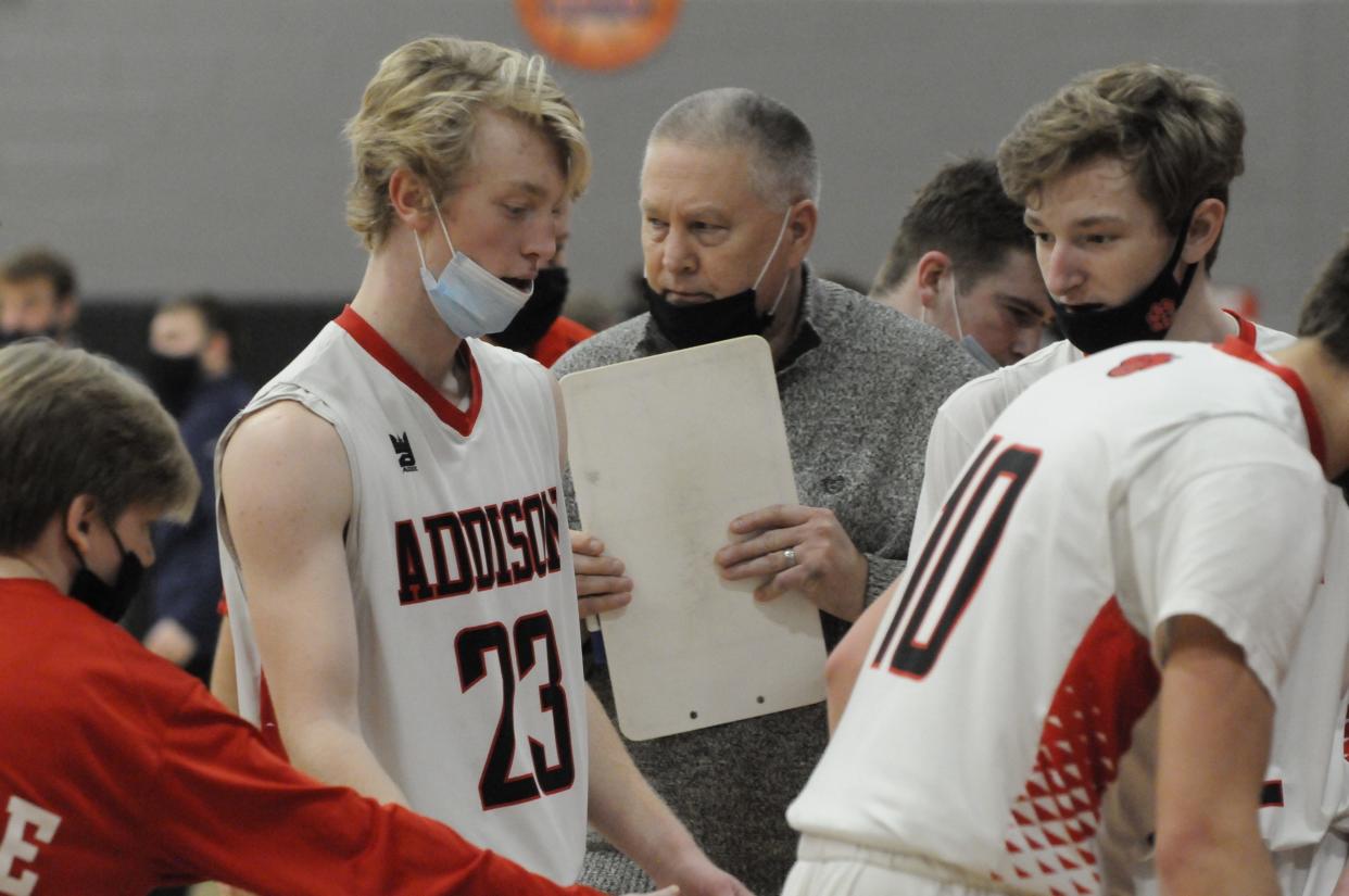 Addison head coach Marv Cox talks to Kenny Jarchow (23) and Spencer Brown (right) during a game against East Jackson in 2021.