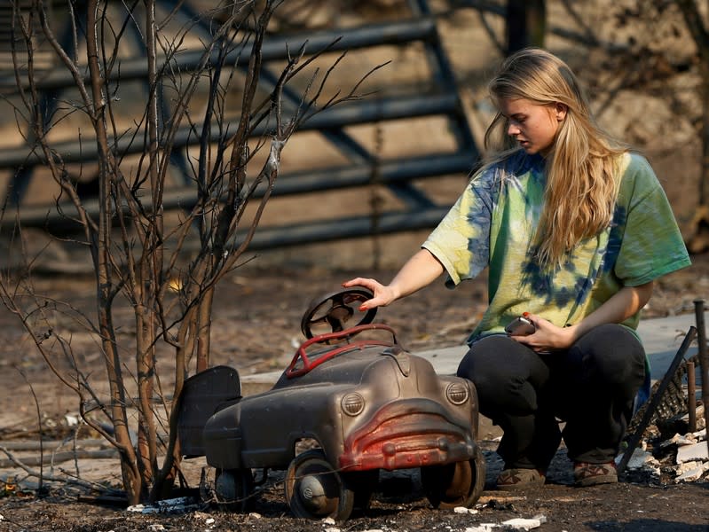 Stephanie and Ashley LaFranchi walk amidst rubbles of a burned down family home at Oak Hill Angus in Calistoga, California