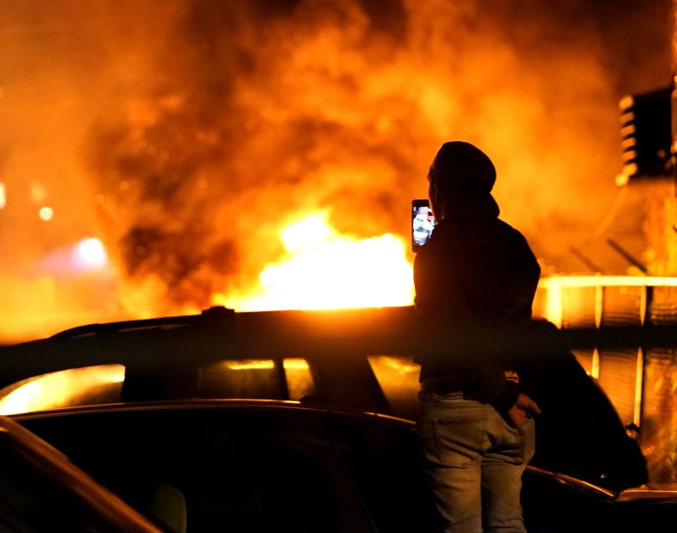 Several cars burn near a gas station during a night of rioting in Minneapolis over the of George Floyd.