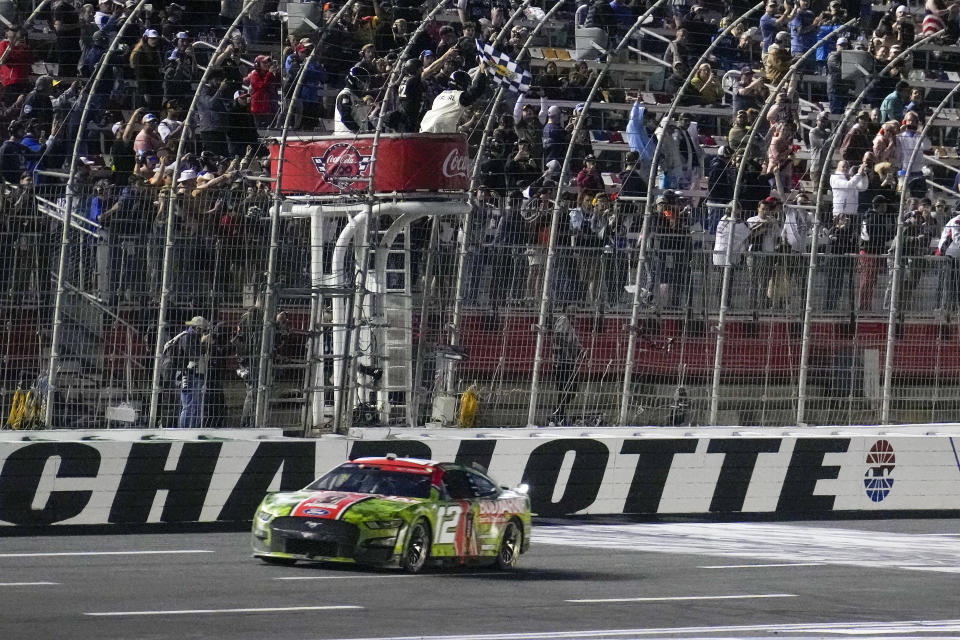 May 29, 2023; Concord, North Carolina, USA; NASCAR Cup Series driver Ryan Blaney (12) takes the checkered flag during the Coca-Cola 600 at Charlotte Motor Speedway. Mandatory Credit: Jim Dedmon-USA TODAY Sports