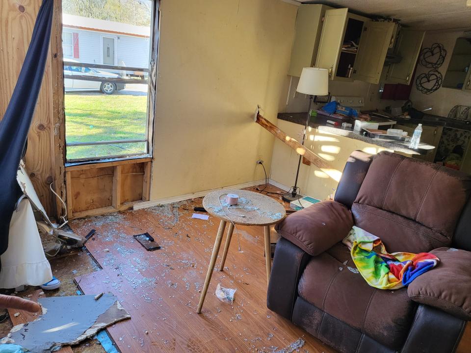 A two-by-four sticks through the side of a trailer after being hurled by a tornado that struck Labadieville Jan. 8.