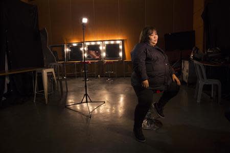 Rose Fostanes,47, a Filipina caregiver, sits during her interview with Reuters in a dressing room before a rehearsal for Israel's X-Factor talent show in Tel Aviv January 12, 2014. REUTER/Baz Ratner