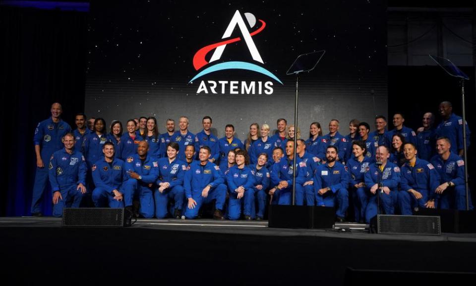 Artemis team members pose for a photo during NASA’s announcement of the Artemis II crew.