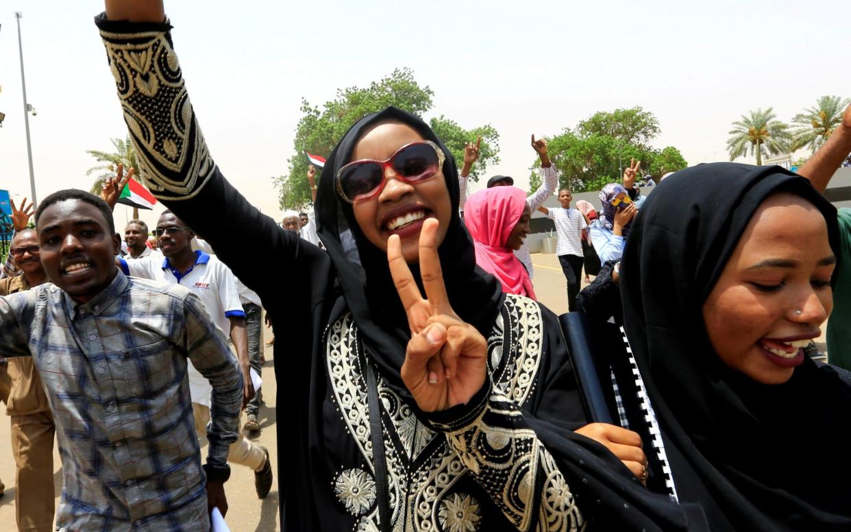 Sudanese people celebrate the signing of a new constitution in Khartoum - REUTERS