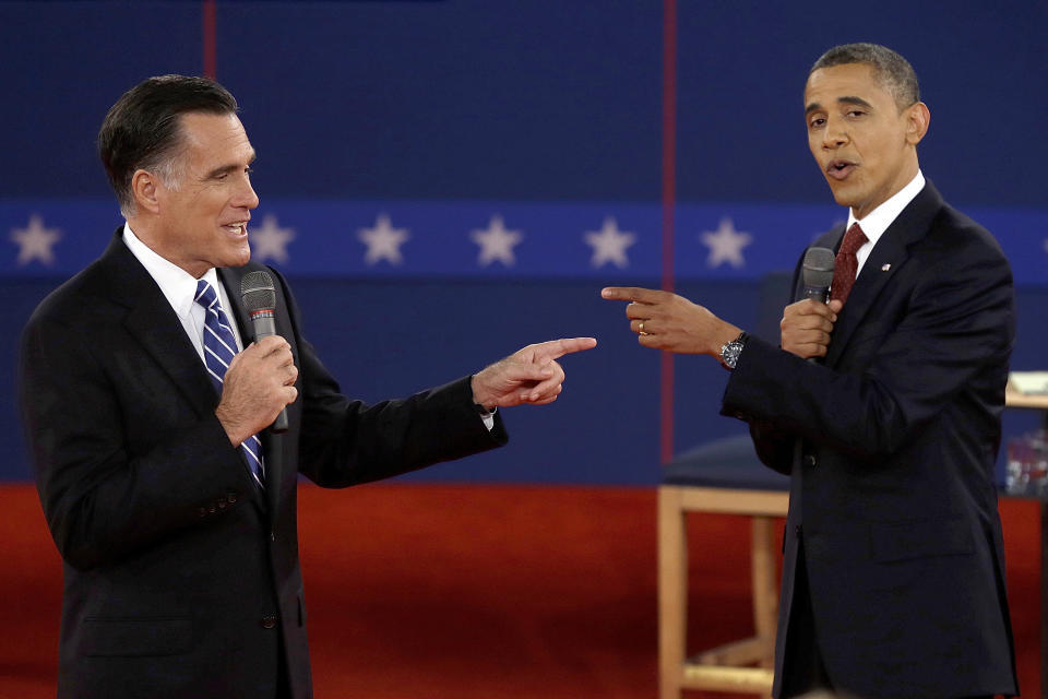 FILE - Republican presidential nominee Mitt Romney, left, and President Barack Obama spar during the second presidential debate on Oct. 16, 2012, in Hempstead, N.Y. Romney, who participated in three debates against Obama, said "of course" former President Donald Trump and President Joe Biden should debate. "This is a democracy of the United States of America. We need to hear from the people who want to be president and see if they have mental capacity and see what their positions are on issues." (AP Photo/Charlie Neibergall, File)