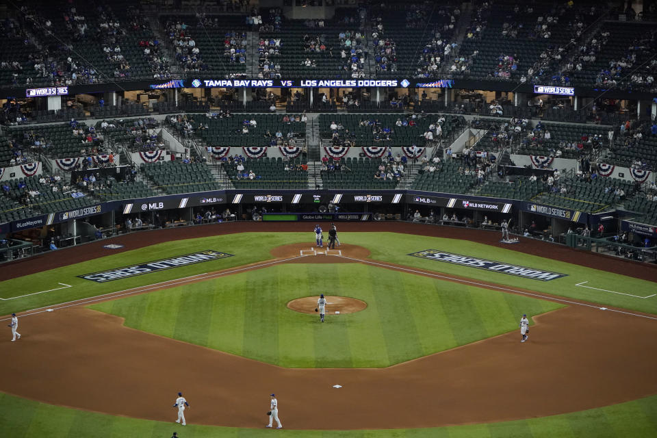 A limited number of spectators watch the Los Angeles Dodgers play against the Tampa Bay Rays during the first inning in Game 2 of the baseball World Series Wednesday, Oct. 21, 2020, in Arlington, Texas. (AP Photo/Sue Ogrocki)