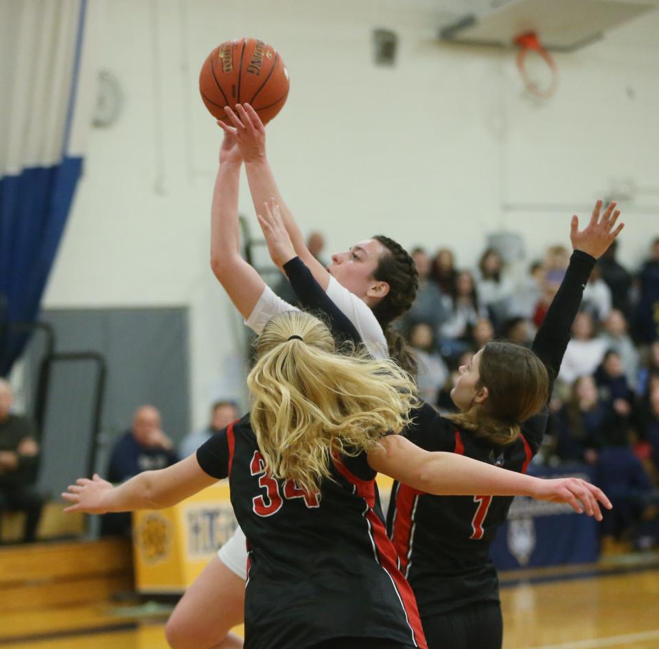 Highland's Danica Valente goes up for a shot against Onteora's, from left, Vivienne Lamb and Lilyana Degondea-Heaney, during a Section 9 Class B girls basketball semifinal on Feb. 27, 2024.