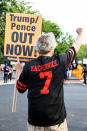 WASHINGTON, DC - AUGUST 27: A man wearing a Colin Kaepernick jersey raises his fist towards the White House on August 27, 2020 in Washington, DC. Protesters gathered on the final night of the Republican National Convention in which both President Donald Trump Vice President Mike Pence accepted the Republican nomination as candidates for a second term as U.S. President. (Photo by Natasha Moustache/Getty Images)